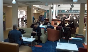 Attendees relaxing on sofas.