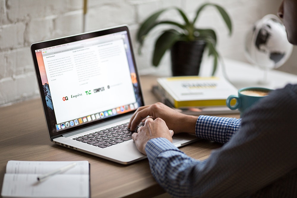Image shows a person using a laptop keyboard